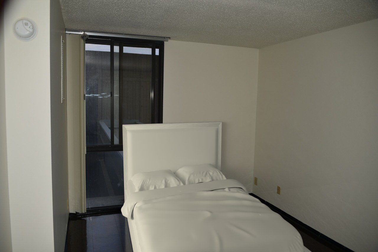 Queen bed against a 9 ft bedroom wall